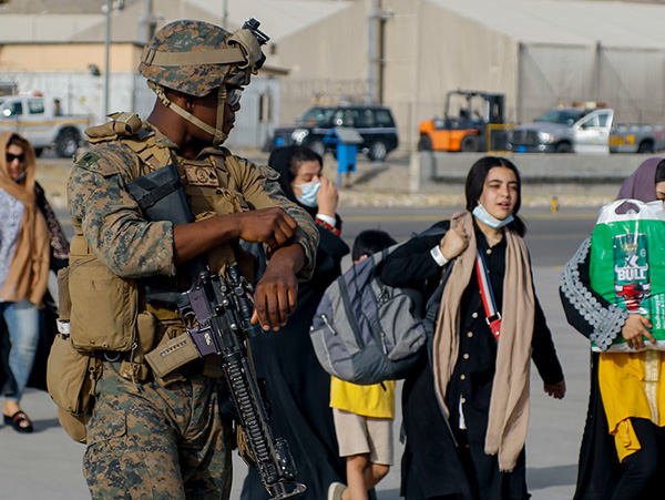 Afghan refugees waiting to board a U.S. military plane