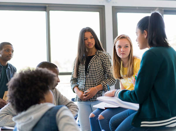 diverse group of teens discuss community plans for improvement