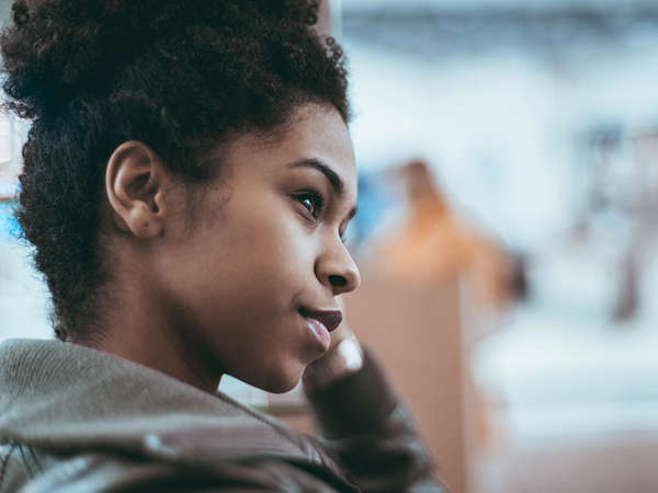 african american teen girl listens to program officer in her treatment class