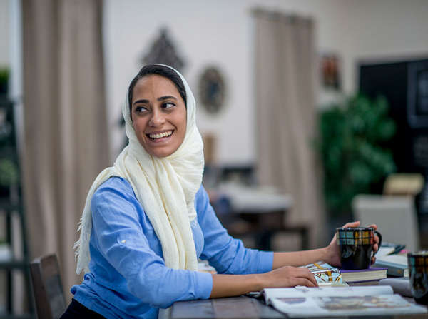 middle eastern refugee woman works at her office job
