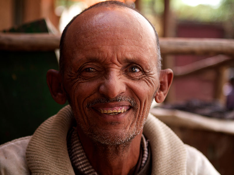 Refugee man smiles as he settles into his new community in the U.S.