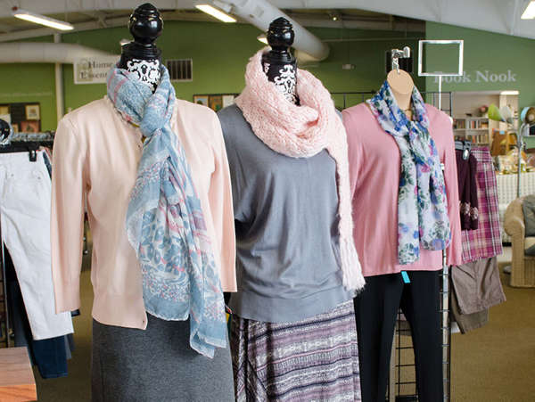 women's mannequins display pink and gray sweaters and scarves