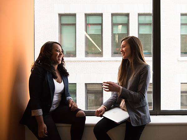 Woman experiencing an unplanned pregnancy talks with pregnancy counselor about how to give a baby up for adoption.