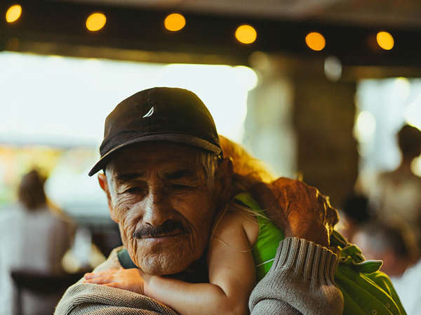 elderly refugee man reunites with his granddaughter in the U.S.