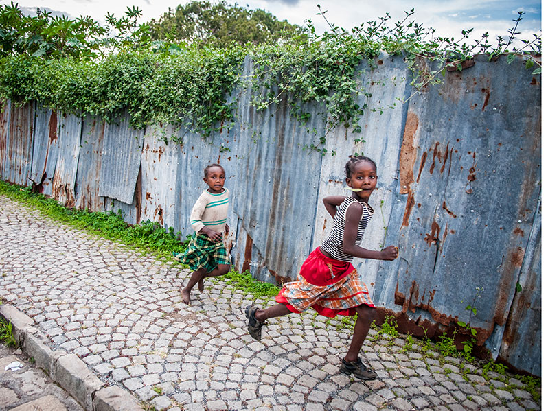 ethiopian children run on the sidewalk in ethiopia