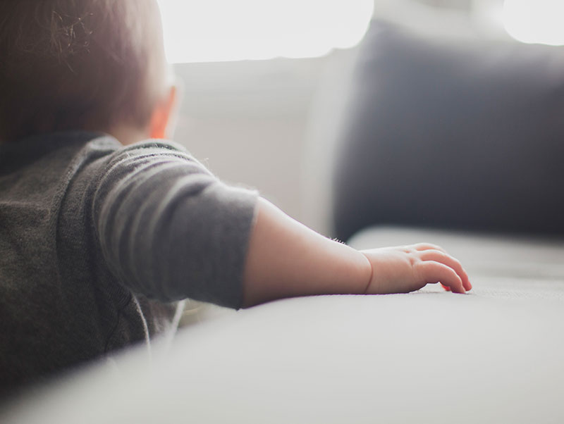 toddler climbs on bed