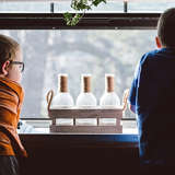 two young boys in foster care look out the window of their foster parents' home