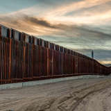 the large, metal wall dividing the border between mexico and U.S.