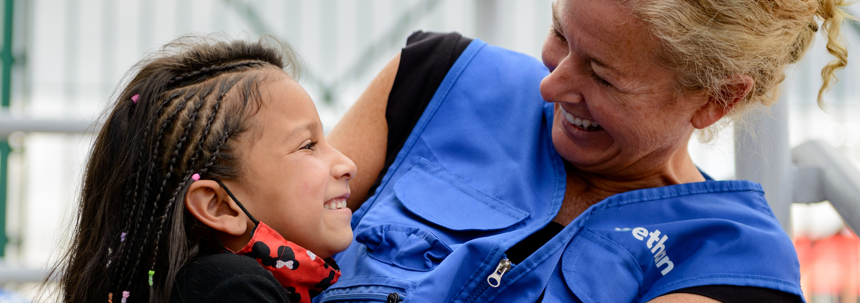 refugee worker makes young Venezuelan girl smile