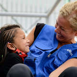 refugee worker makes young Venezuelan girl smile