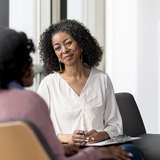 Black, female social worker counsels a teenage girl