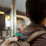 African refugee youth walking through an airport