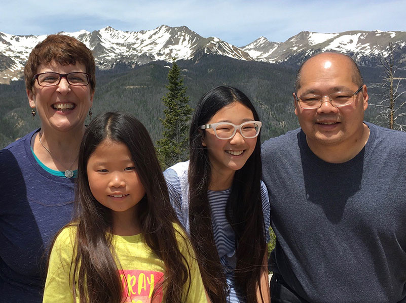 diverse family joined through adoption takes a vacation in the mountains