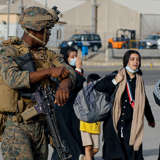 Afghan refugees waiting to board a U.S. military plane